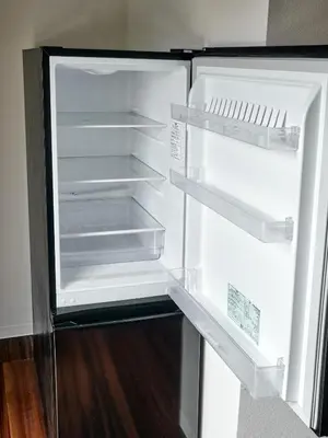 an empty refrigerator with its door open in a room at asanagi in Tokyo