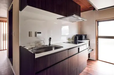a kitchen with a sink and a microwave at asanagi in Tokyo
