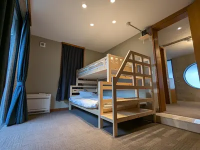 a bedroom with a bunk bed with a ladder at Family and Group stay, Private house close to Shinjuku in Tokyo