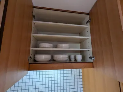 a cupboard with white dishes in it at Family and Group stay, Private house close to Shinjuku in Tokyo