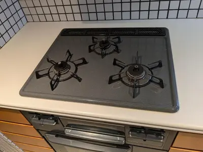 a stove top with three burners on a kitchen counter at Family and Group stay, Private house close to Shinjuku in Tokyo