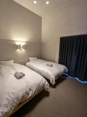 a bedroom with two beds and a window at Family and Group stay, Private house close to Shinjuku in Tokyo