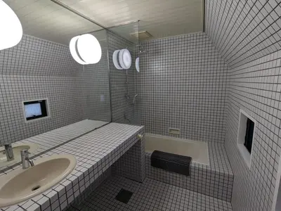 a white tiled bathroom with a sink and a tub at Family and Group stay, Private house close to Shinjuku in Tokyo