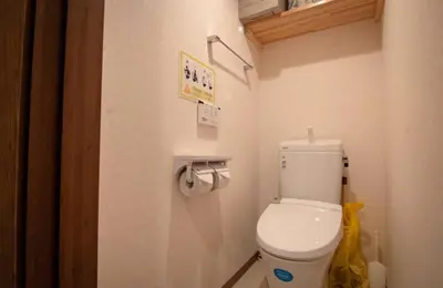 a bathroom with a white toilet in a room at Daily Urban Lodge \u65b0\u5bbf\u30bc\u30f37 in Tokyo