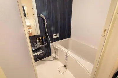 a bathroom with a bath tub and a shower at Daily Urban Lodge \u65b0\u5bbf\u30bc\u30f37 in Tokyo