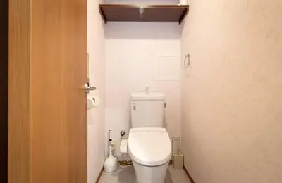 a bathroom with a toilet in a small room at Daily Urban Lodge \u65b0\u5bbf\u30bc\u30f37 in Tokyo