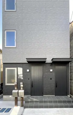 a building with two sets of garage doors on it at Kichi in Tokyo
