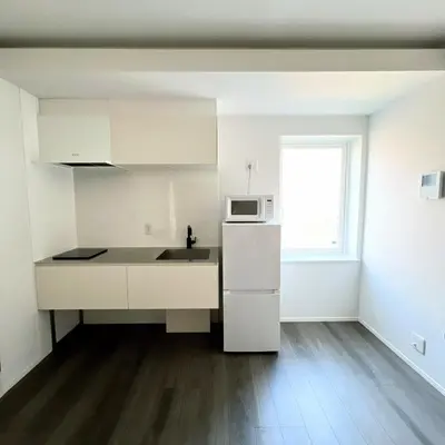 a white kitchen with a sink and a microwave at Kichi in Tokyo
