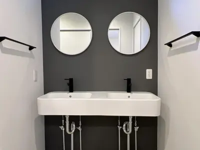 a bathroom with two mirrors and a white sink at Kichi in Tokyo