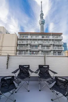 a group of chairs sitting in front of a building at New house Solamachi Tokyo 5 min walk, Asakusa 2 min away, direct airport access, great for families and groups in Tokyo