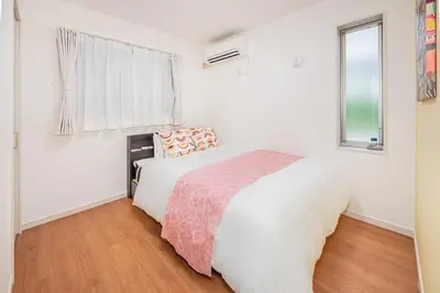 a white bedroom with a bed and a window at New house Solamachi Tokyo 5 min walk, Asakusa 2 min away, direct airport access, great for families and groups in Tokyo