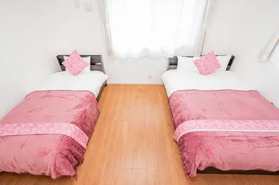 two beds sitting next to each other in a room at New house Solamachi Tokyo 5 min walk, Asakusa 2 min away, direct airport access, great for families and groups in Tokyo