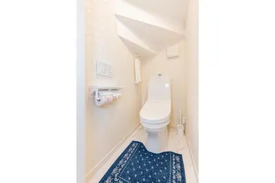a bathroom with a toilet and a blue rug at New house Solamachi Tokyo 5 min walk, Asakusa 2 min away, direct airport access, great for families and groups in Tokyo