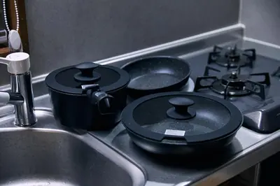 a kitchen stove with two pots and pans on it at NATURE BASE TOKYO Horikiri in Tokyo