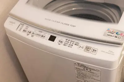 a washing machine with a white clean class top at Forest Guest House Shinjuku city center in Tokyo