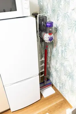 a vacuum cleaner next to a refrigerator at Forest Guest House Shinjuku city center in Tokyo