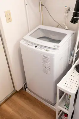 a washer and dryer sitting in a room at Forest Guest House Shinjuku city center in Tokyo