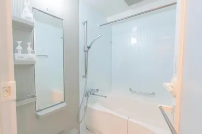 a white bathroom with a shower and a tub at \u9326\u7cf8\u753a \u4e21\u56fd\u30a8\u30ea\u30a2\u8fd1\u304f\u306e\u5feb\u9069\u30b2\u30b9\u30c8\u30cf\u30a6\u30b9 DLoY2 in Tokyo