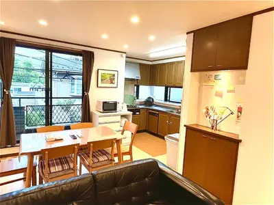 a kitchen and living room with a table and chairs at TSURUNOYA The only private lodging in Tokyo Japanese Tatami style 8 minutes walk from station free Parking new open Asakusa Akihabara Tokyo sky tree Disneyland nearby 110m2 in Tokyo