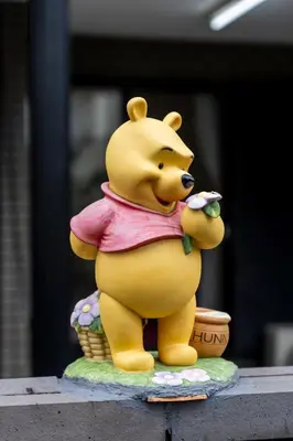 a large yellow bear statue sitting on a table at TSURUNOYA The only private lodging in Tokyo Japanese Tatami style 8 minutes walk from station free Parking new open Asakusa Akihabara Tokyo sky tree Disneyland nearby 110m2 in Tokyo