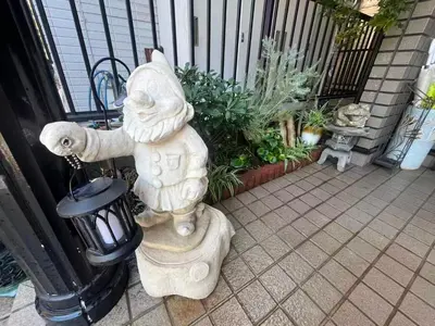 a statue of a cat sitting on a patio at TSURUNOYA The only private lodging in Tokyo Japanese Tatami style 8 minutes walk from station free Parking new open Asakusa Akihabara Tokyo sky tree Disneyland nearby 110m2 in Tokyo