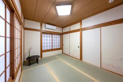 an empty room with a bench and windows at TSURUNOYA The only private lodging in Tokyo Japanese Tatami style 8 minutes walk from station free Parking new open Asakusa Akihabara Tokyo sky tree Disneyland nearby 110m2 in Tokyo