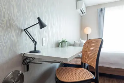 a desk in a room with two chairs and a bed at \u3077\u3075\u304bTk\u6771\u5411\u5cf6301-1min to Higashi Mukojima Sta 3F Cozy Stay Near Skytree Asakusa in Tokyo