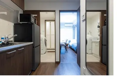 a kitchen with a sink and a refrigerator in a room at \u3077\u3075\u304bTk\u6771\u5411\u5cf6301-1min to Higashi Mukojima Sta 3F Cozy Stay Near Skytree Asakusa in Tokyo
