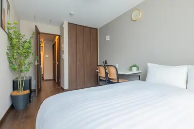 a bedroom with a white bed and a desk and chairs at \u3077\u3075\u304bTk\u6771\u5411\u5cf6301-1min to Higashi Mukojima Sta 3F Cozy Stay Near Skytree Asakusa in Tokyo