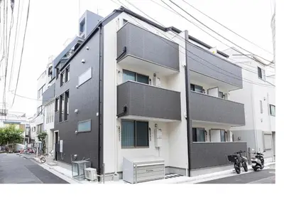 a black and white building on a city street at \u3077\u3075\u304bTk\u6771\u5411\u5cf6302-1min to Higashi Mukojima Sta 3F Cozy Stay Near Skytree Asakusa in Tokyo