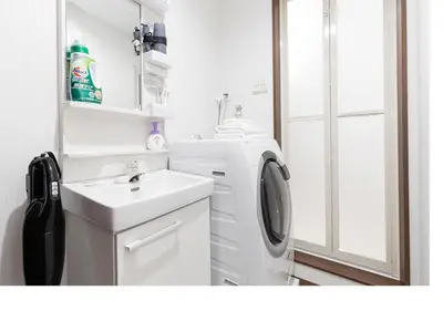 a white bathroom with a washing machine and a sink at \u3077\u3075\u304bTk\u6771\u5411\u5cf6303-1min to Higashi Mukojima Sta 3F Cozy Stay Near Skytree Asakusa in Tokyo