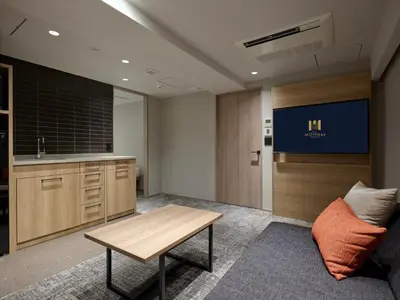 an office with a desk and a table and a couch at Premium Apart MONday GINZA EAST in Tokyo