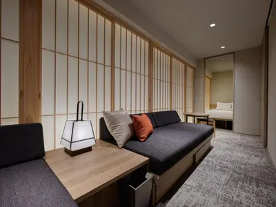 a room with a couch and a bed and a bedroom at Premium Apart MONday GINZA EAST in Tokyo