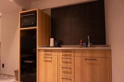 a kitchen with a sink and a microwave at Premium Apart MONday GINZA EAST in Tokyo
