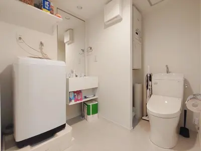 a white bathroom with a toilet and a sink at Mi-HOTEL KAGURAZAKA in Tokyo