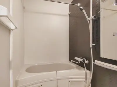 a small bathroom with a tub and a toilet at Mi-HOTEL KAGURAZAKA in Tokyo