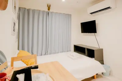 a small room with a bed and a television at Mi-HOTEL KAGURAZAKA in Tokyo