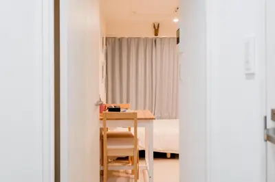 a room with a desk and a bed and a table at Mi-HOTEL KAGURAZAKA in Tokyo