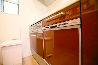 a kitchen with a refrigerator and a dishwasher at HAMA HILLS Shinjuku House in Tokyo
