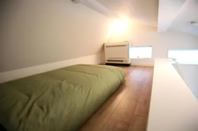 a bedroom with a bed and a dresser in it at HAMA HILLS Shinjuku House in Tokyo