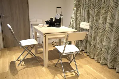 a table with two chairs and a coffee maker on it at Koenji Nakano VILLA - Vacation STAY 00734v in Tokyo