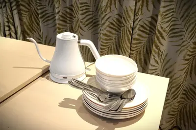 a stack of plates and forks and spoons on a table at Koenji Nakano VILLA - Vacation STAY 00734v in Tokyo