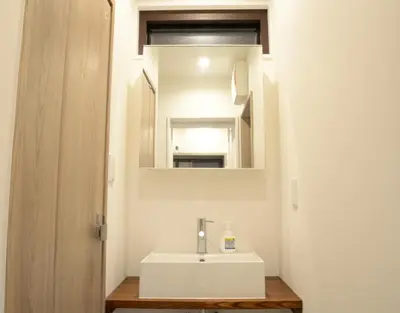 a bathroom with a white sink and a mirror at Koenji Nakano VILLA - Vacation STAY 00734v in Tokyo