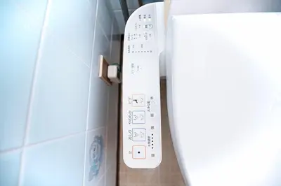 a white wii remote control sitting on a wall at Zen Sleep Tokyo Ikegami in Tokyo