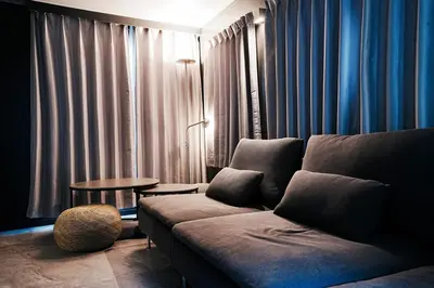 a living room with a couch and a table at Zen Sleep Tokyo Ikegami in Tokyo