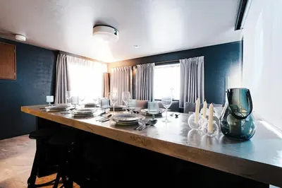 a dining table with plates and glasses on it at Zen Sleep Tokyo Ikegami in Tokyo