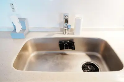 a sink with a faucet in a kitchen at Zen Sleep Tokyo Ikegami in Tokyo