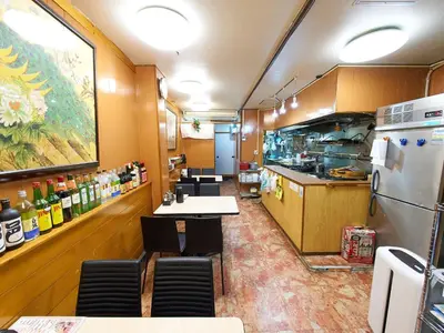 a kitchen with tables and chairs and a refrigerator at Koka House TOKYO ASAKUSA in Tokyo