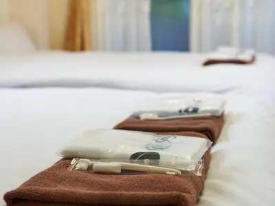 two towels sitting on top of a bed at Koka House TOKYO ASAKUSA in Tokyo