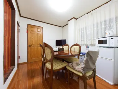 a kitchen and dining room with a table and chairs at Koka House TOKYO ASAKUSA in Tokyo